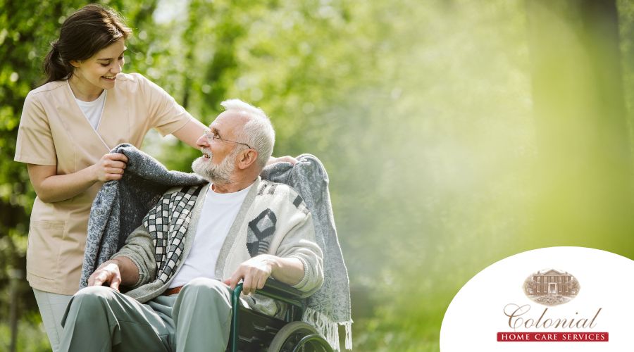 A caregiver puts blanket around an older client representing the quality care that veteran home care services can provide.