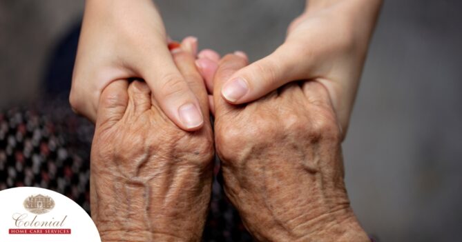 Younger hands hold older ones, representing the care and compassion of caregiving and how caregivers can help, even in ways like implementing stroke prevention strategies.