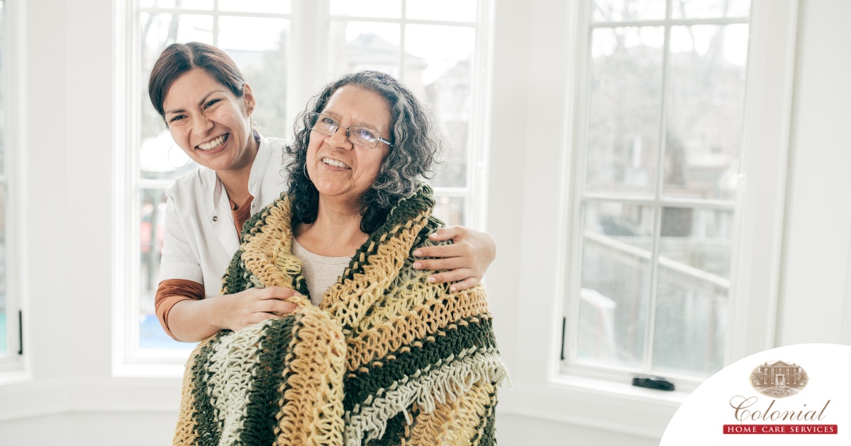 A caregiver hugs an older client representing the kind of good environment a caregiver has the potential to create with new clients.